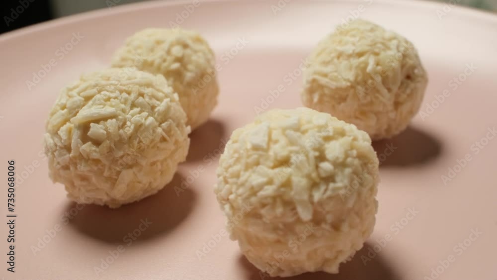 White chocolate wafers on pink plate rotating 360 degrees White chocolate wafers on pink plate rotating 360 degrees