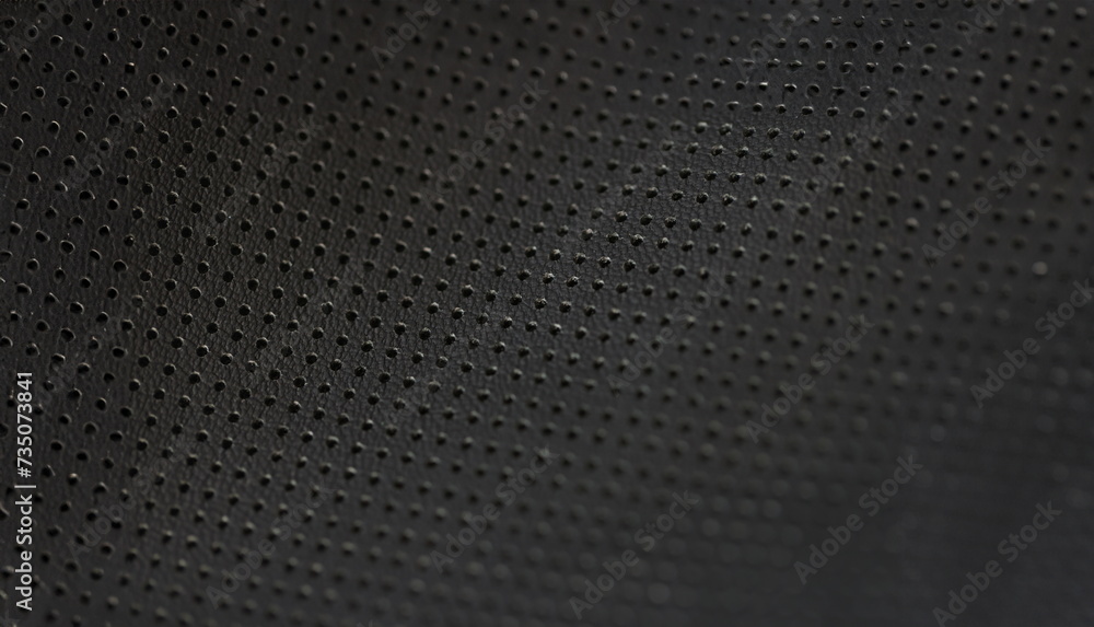 Black leather fabric pattern of small holes, close-up. Perforated matte texture. A macro shot of dark background Black leather fabric pattern of small holes, close-up. Perforated matte texture. A macro shot of dark background