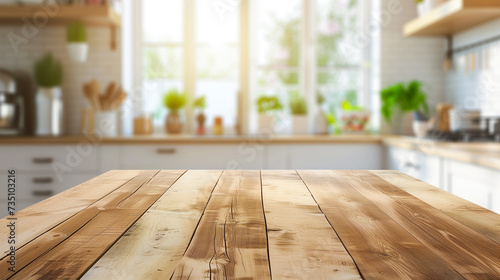 Beautiful empty brown wooden table top and blurred defocused modern kitchen interior background with daylight flare, product montage display.
