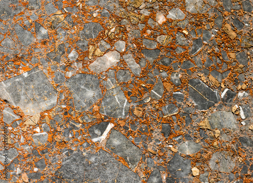 Rust texture on the rock block mixed with marble and iron which has been used as a column body on a colonnaded road in the ancient city of Castabala. photo