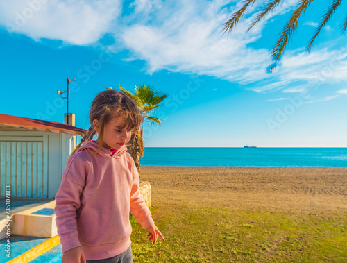 Beautiful Spanish girl walking on the beach of Malagueta in Malaga, Spain