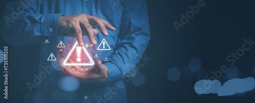 Businessman use hands control triangle caution warning. cyber attack on online network error system. Triangle caution warning sign exclamation for notification error. photo