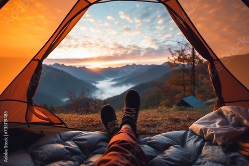 Time for yourself. Woman cross leg on blanket in camping tent with sleeping bags on mountain hill. view from inside with. mountains