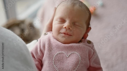 Solicitous Mother Gently Rocks Her Adorable Infant Baby Girl