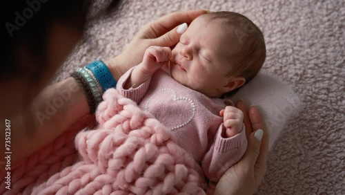 Solicitous Mother Gently Rocks Her Adorable Infant Baby Girl