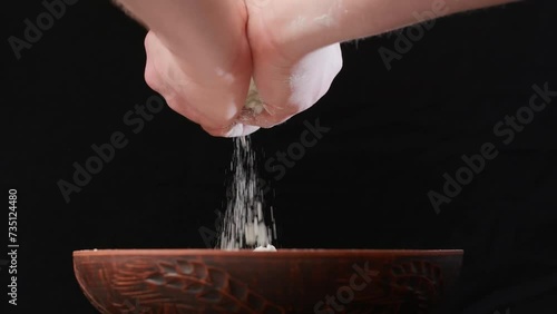 Men's hands pour white flour
