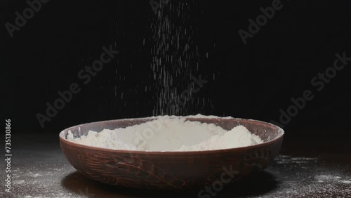 Men's hands pour white flour
