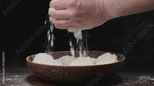 Men's hands pour white flour