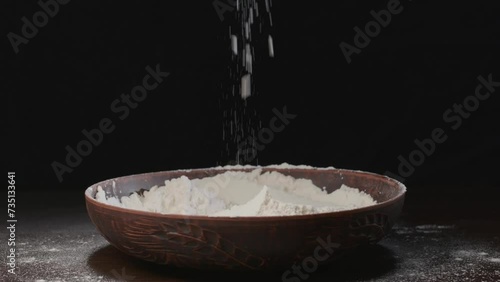 Men's hands pour white flour