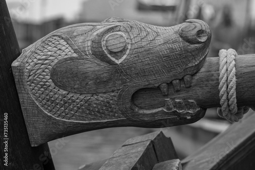 Ornately carved wooden dragon head, black and white photo