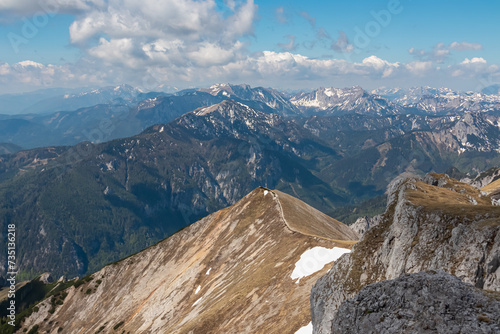 Panoramic view from mountain summit Foelzstein in wild Hochschwab massif, Styria, Austria. Looking at majestic Ennstaler Alps in Gesaeuse national park in distance. Wanderlust in remote Austrian Alps photo