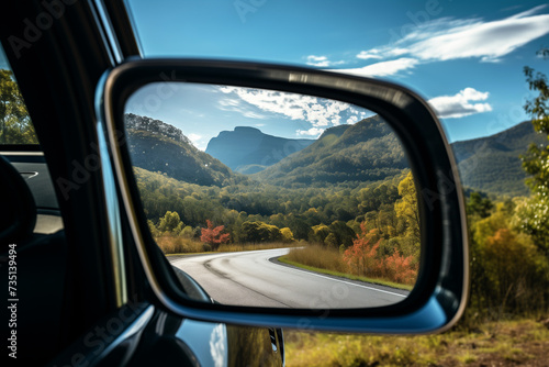 a zoomed or close-up image of a car front mirror with a beautiful view of Landscapes