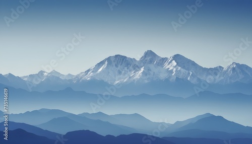 A long distance image of a mountain range in blue tones with copy space