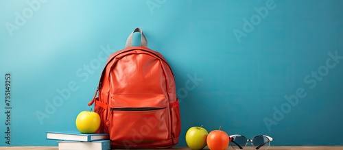 School organization Side view photo of teddy bear schoolbag filled with school essentials pens pencils notebook and more Open book and an apple bring a playful element to the scene. Creative Banner photo