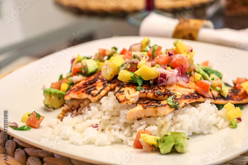 Roasted Grilled salmon with pineapple, cilantro, and rice, cooked to perfection in a restaurant