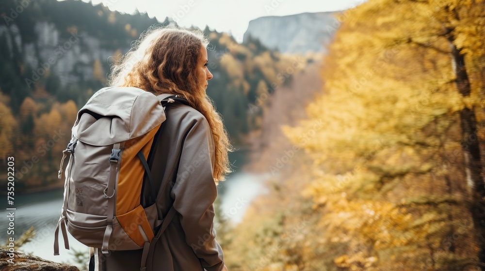 Rear view of a woman walking up a mountain.woman with backpack travels in the mountains Rear view of a woman walking up a mountain.woman with backpack travels in the mountains