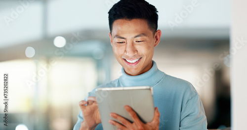 Asian man with tablet, smile and scroll, thinking and reading email, review or article at startup. Internet, research and happy businessman with digital app for with networking, social media or web.