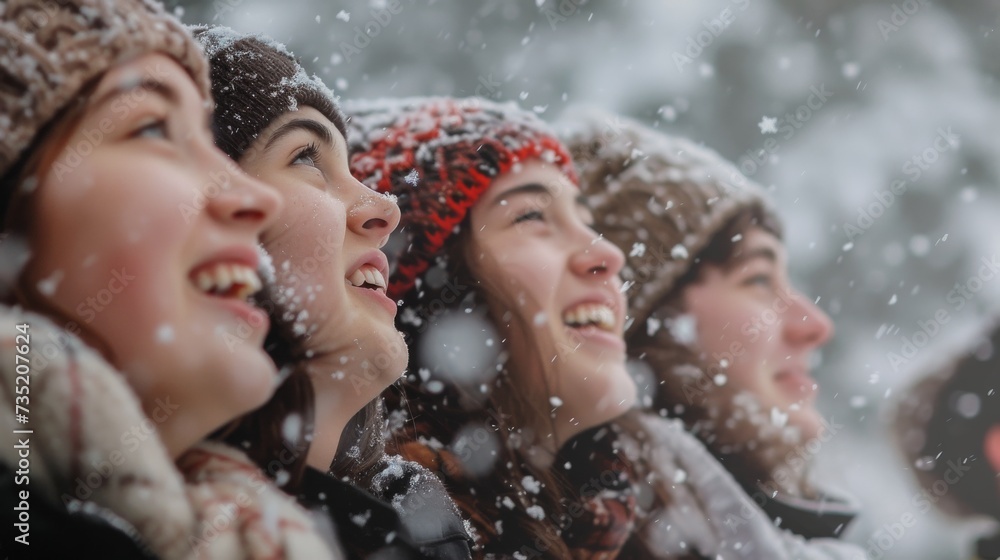 Fototapeta premium A group of stylish women, their faces adorned with hats, stand in the snowy landscape, braving the winter weather together