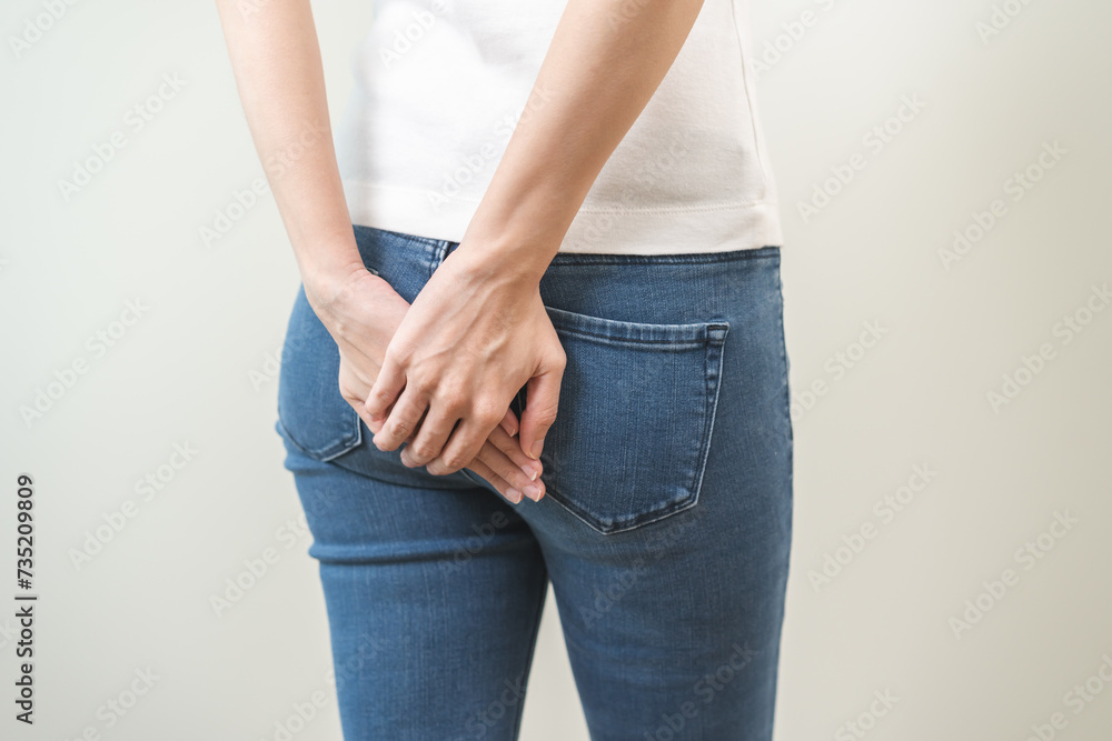 Health care, pain asian young woman suffering from hemorrhoid, anus, diarrhea and constipation, girl hand touching, holds butt, anal have abdominal, intestine problem, abscess disease and smell fart. - obrazy, fototapety, plakaty 