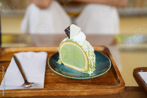 Obraz na plátně piece of Ice cream cake with matcha and white chocolate on plate and wooden tray