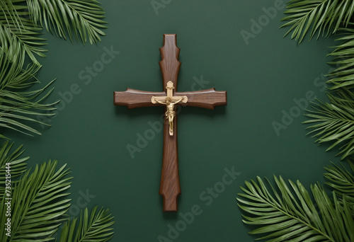 Wooden cross and palm fronds on deep green backdrop, aerial perspective