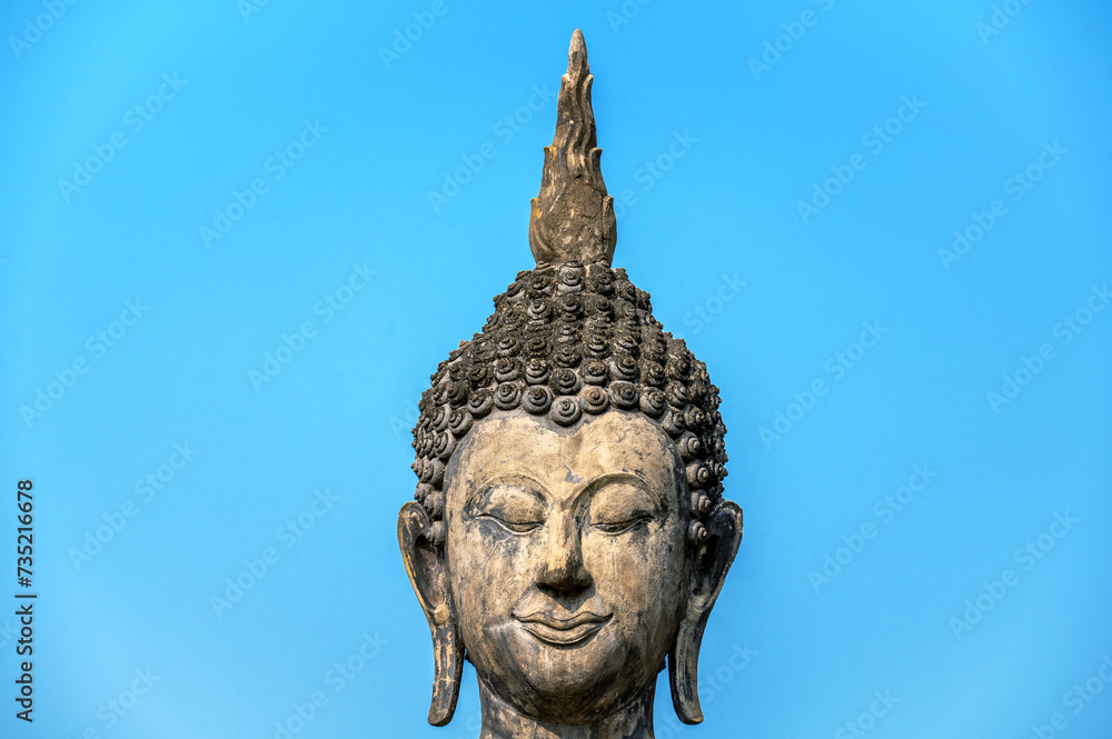 Closeup view of the face of a Buddha statue in Sukhothai, Thailand