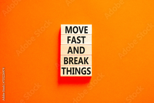 Move fast and break things symbol. Concept words Move fast and break things on wooden blocks. Beautiful orange table orange background. Business, move fast and break things concept. Copy space.