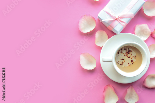 Love composition - coffee cup and gift box on pink background. Valentine's day greeting card. Copy space for the text