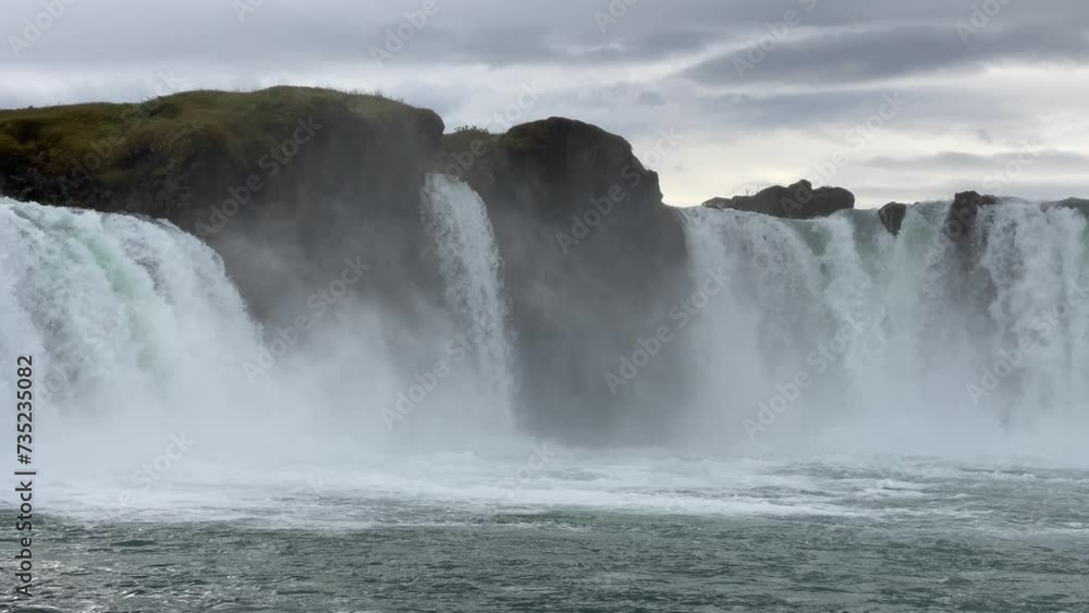 Traveling and exploring Iceland landscapes and famous places. Autumn tourism by Atlantic ocean and mountains. Outdoor views on beautiful cliffs and travel destinations. Godafoss waterfall. Traveling and exploring Iceland landscapes and famous places. Autumn tourism by Atlantic ocean and mountains. Outdoor views on beautiful cliffs and travel destinations. Godafoss waterfall.