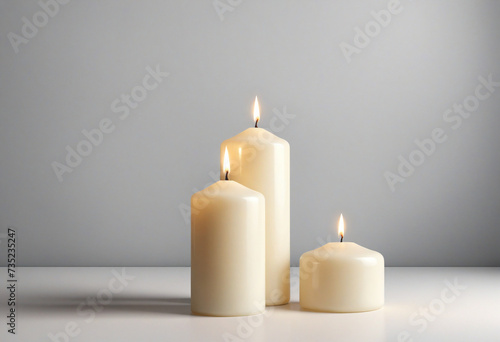 Two white candles on bright background for product or text
