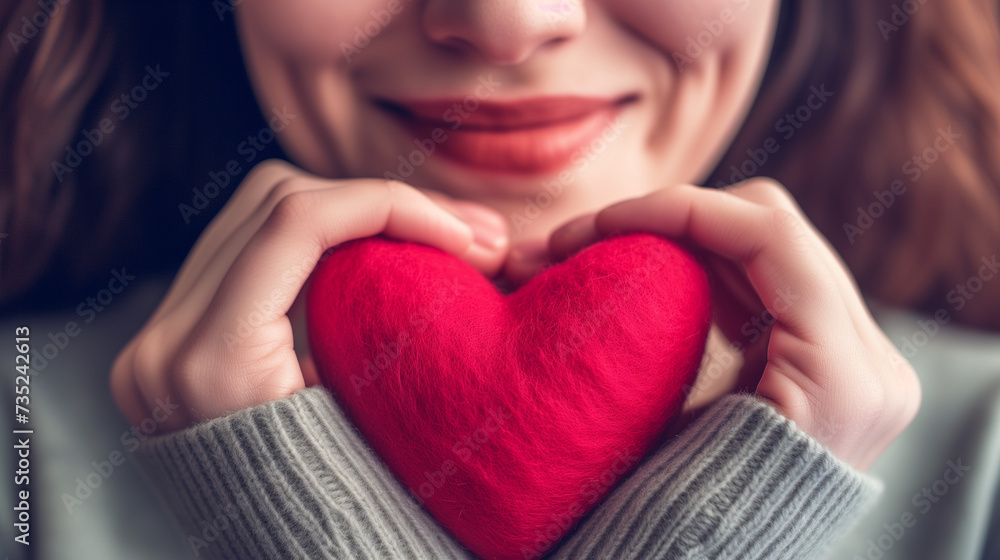 Young happy woman holding decorative heart Young happy woman holding decorative heart