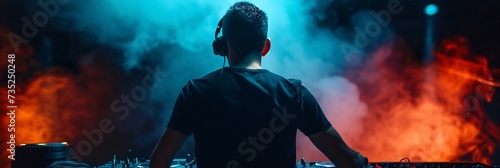 a man wearing headphones and a dj's turntable