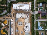 the construction site of an apartment building in the summer from a height