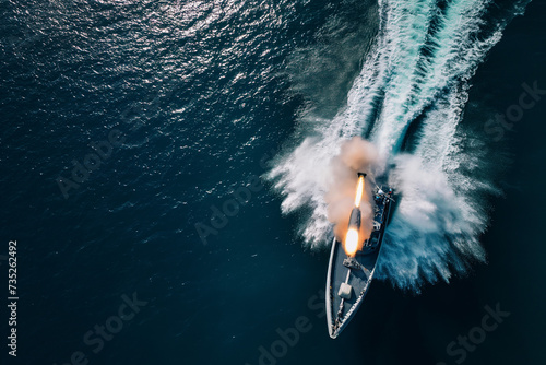 aerial view of a boat firing a torpedo in the sea photo