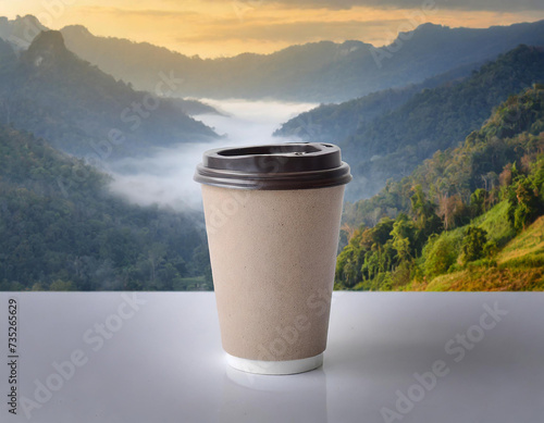 Disposable paper coffee cup on a gray background with sunlight. photo