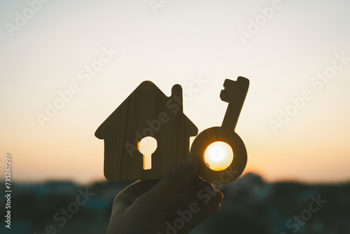 House model and hole key on wood table. Real estate agent offer house, property insurance and security, affordable housing concepts. 