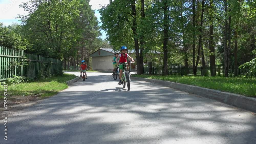 Three happy children riding on bicycle. Enjoying a Ride Through the Park. Urban biking - teens and bikes in city park. Happy friends having fun riding bike at city park. Happy boys on bikes. Brothers Three happy children riding on bicycle. Enjoying a Ride Through the Park. Urban biking - teens and bikes in city park. Happy friends having fun riding bike at city park. Happy boys on bikes. Brothers