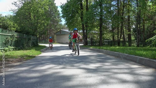 Wallpaper Mural Three happy children riding on bicycle. Enjoying a Ride Through the Park. Urban biking - teens and bikes in city park. Happy friends having fun riding bike at city park. Happy boys on bikes. Brothers  Torontodigital.ca