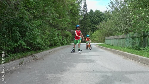 Wallpaper Mural Kids biking and rollerblading. Boy riding on roller skates at outdoor. Boy riding bike wearing a helmet. Young boy enjoying roller skating. Greatest pleasures, riding a bike and rollerblading. Torontodigital.ca