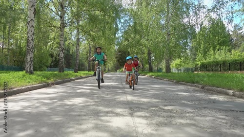 Wallpaper Mural Three happy children riding on bicycle. Enjoying a Ride Through the Park. Urban biking - teens and bikes in city park. Happy friends having fun riding bike at city park. Happy boys on bikes. Brothers  Torontodigital.ca