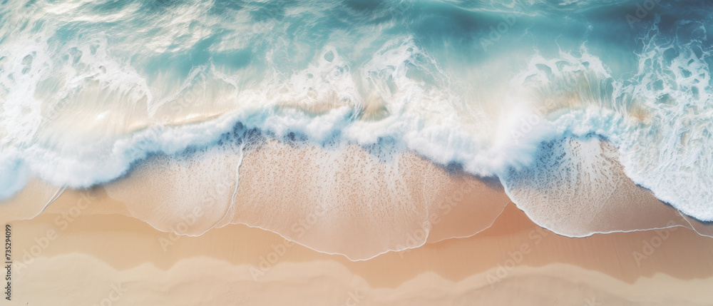 Obraz premium Aerial View of Ocean Waves Meeting Sandy Beach with Foam and Clear Turquoise Water