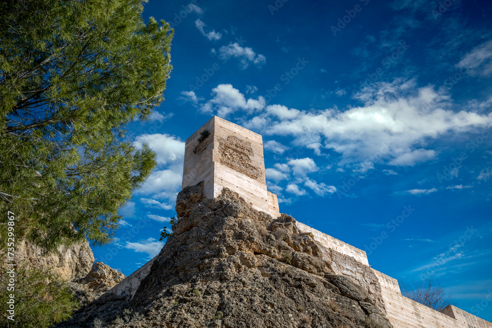 View from below, of one of the towers of the castle of San Juan in Calasparra, Region of Murcia, Spain, on a sunny day