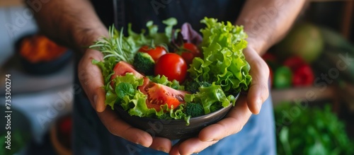 Healthy lifestyle concept with person holding a delicious bowl of fresh organic vegetables