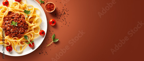 Spaghetti Bolognese with Basil and Cherry Tomatoes on Terracotta Background photo
