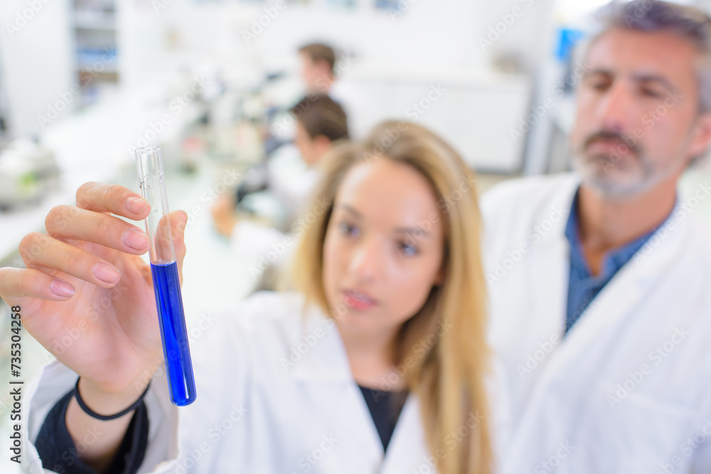 Female scientist holding test tube Female scientist holding test tube