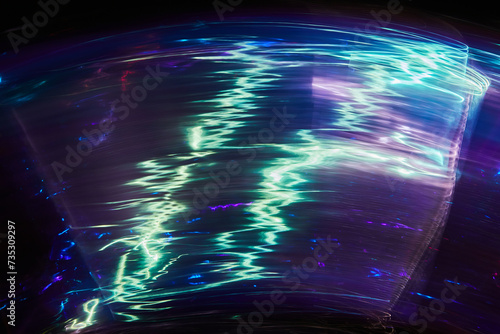 Long exposure photo of vibrant colours on a black background. Multicolored dynamic Light painting. Soft rainbow light flares overlay. Abstract art.