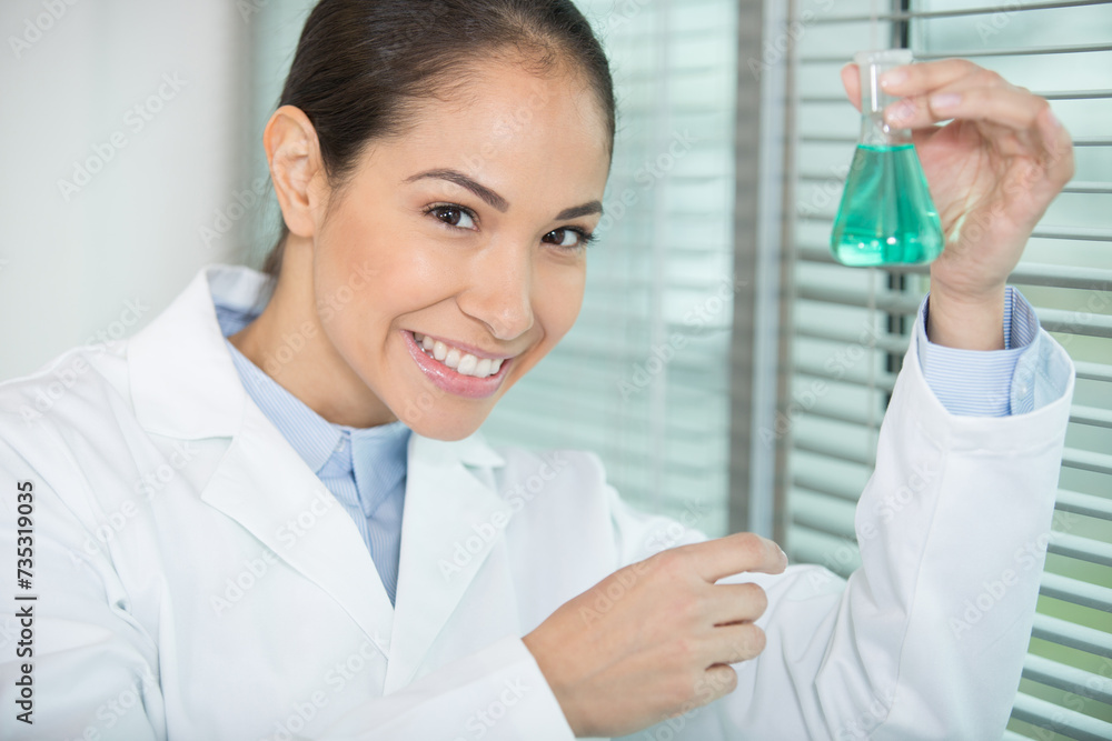 beautiful female scientist holding erlenmeyer flask beautiful female scientist holding erlenmeyer flask