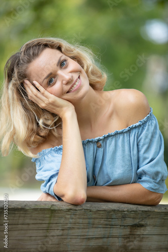 beautiful woman sitting on a park bench