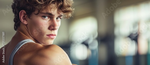 Confident young man at fitness center staring confidently at camera