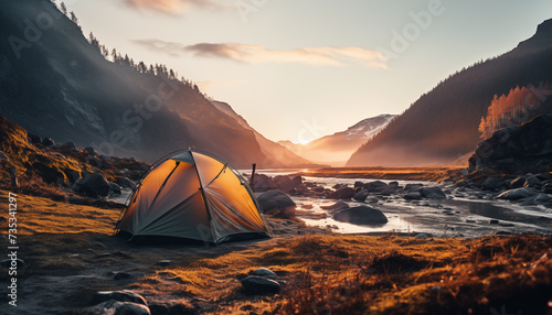 tent against the backdrop of dawn in the mountains near a river with a blurred background